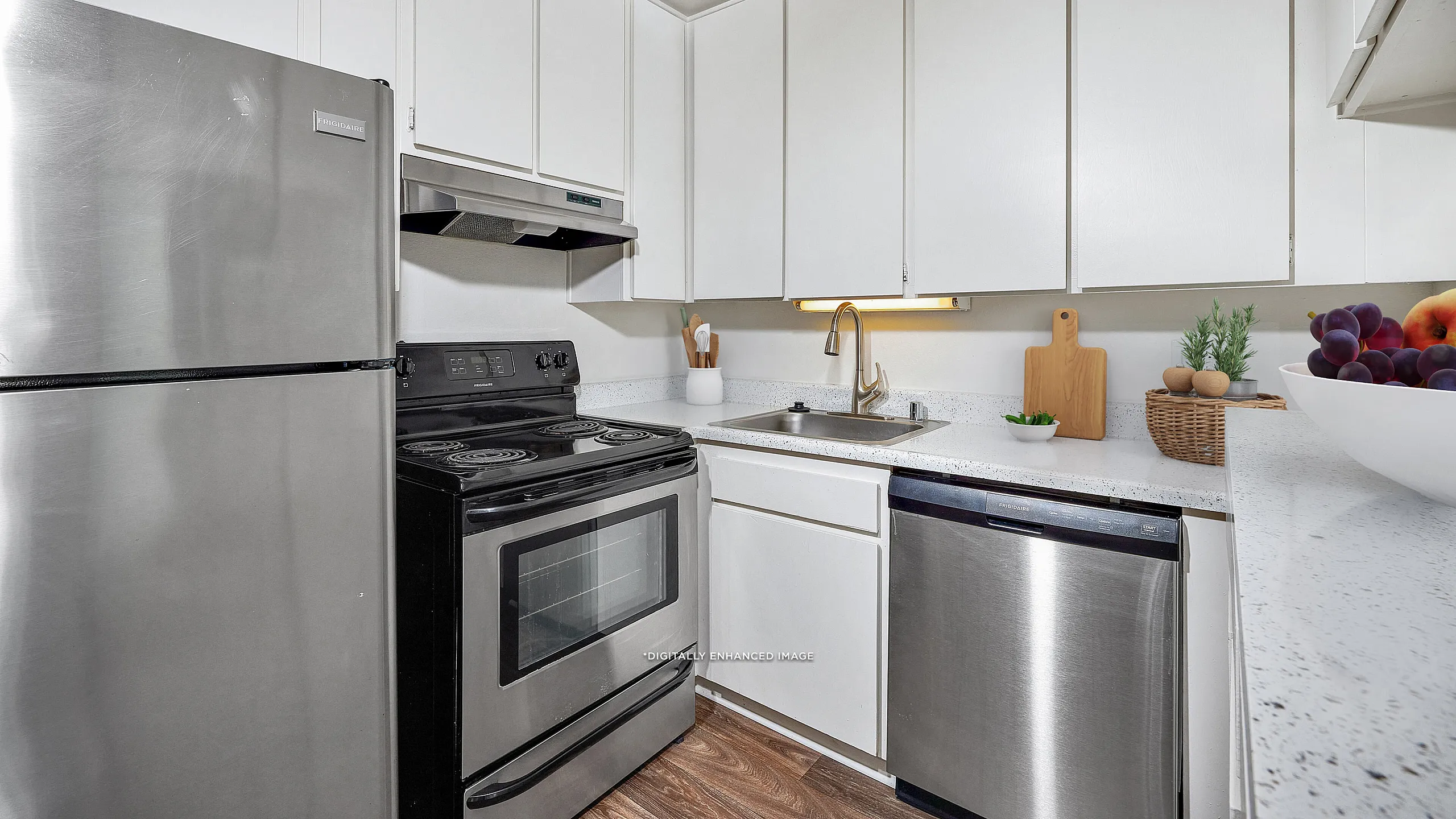 virtually staged - Kitchen with stainless steel appliances and luxury vinyl plank flooring