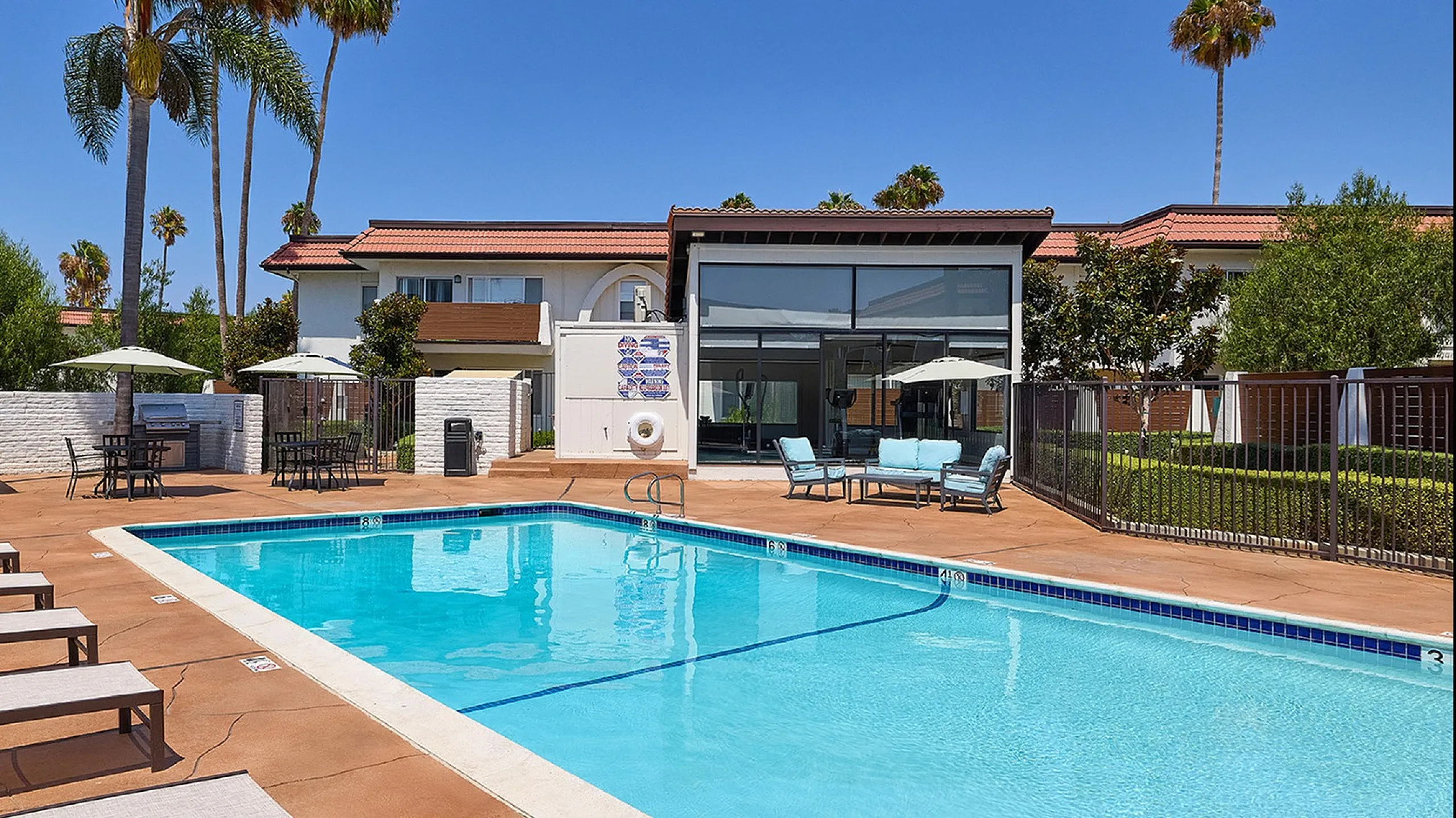 Resort-Style pool and lounge area with white umbrellas