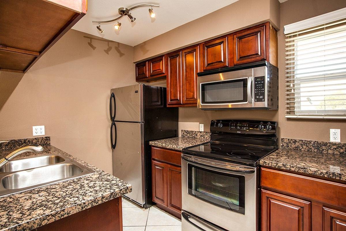 kitchen with granite counters and stainless steel appliances at Solaris at The Biltmore