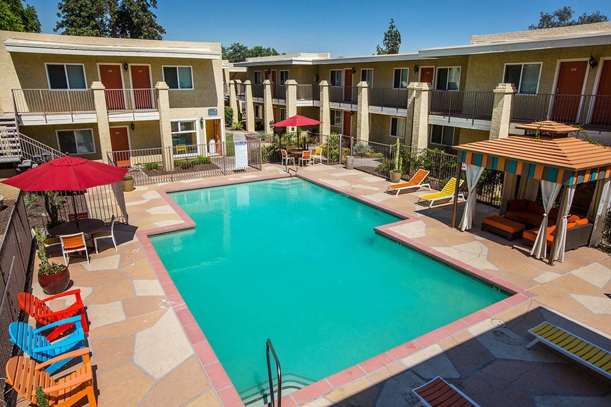 second story view of pool with lounge chairs and poolside cabana at Solaris at The Biltmore