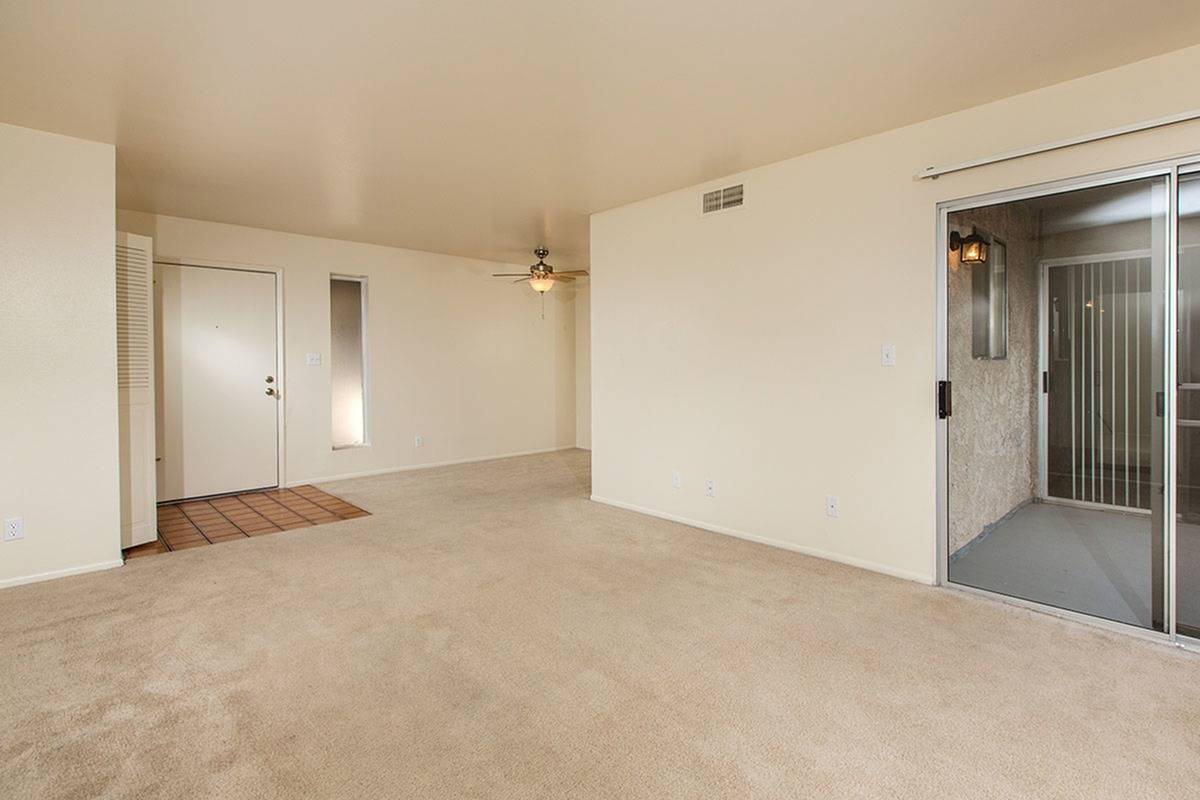 partial view of kitchen and living room with brown carpet at Bridge Lane