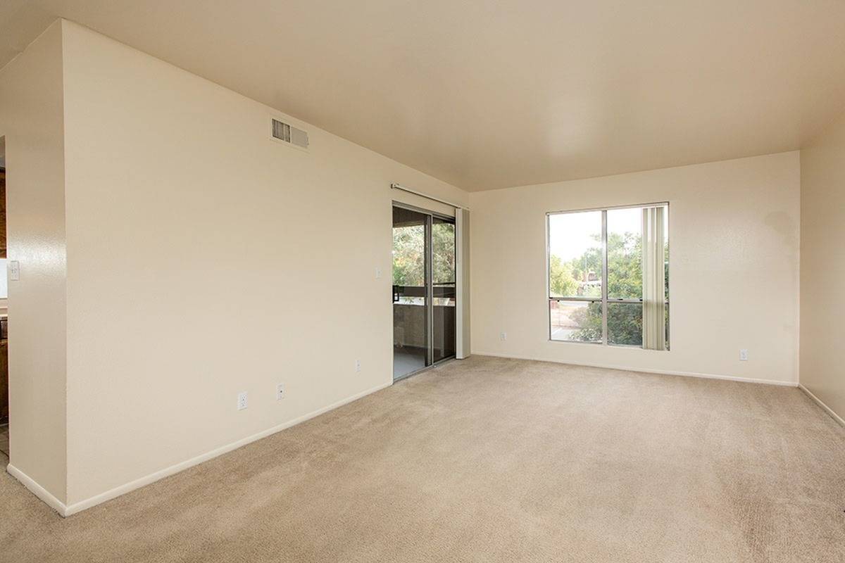 living room with beige carpet and sliding doors to balcony at Bridge Lane