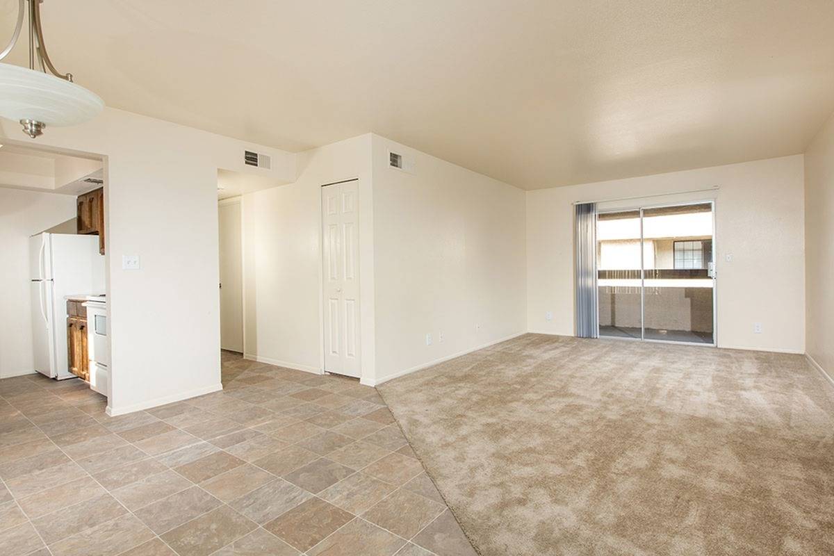 partial view of kitchen and living room with brown carpet at Bridge Lane