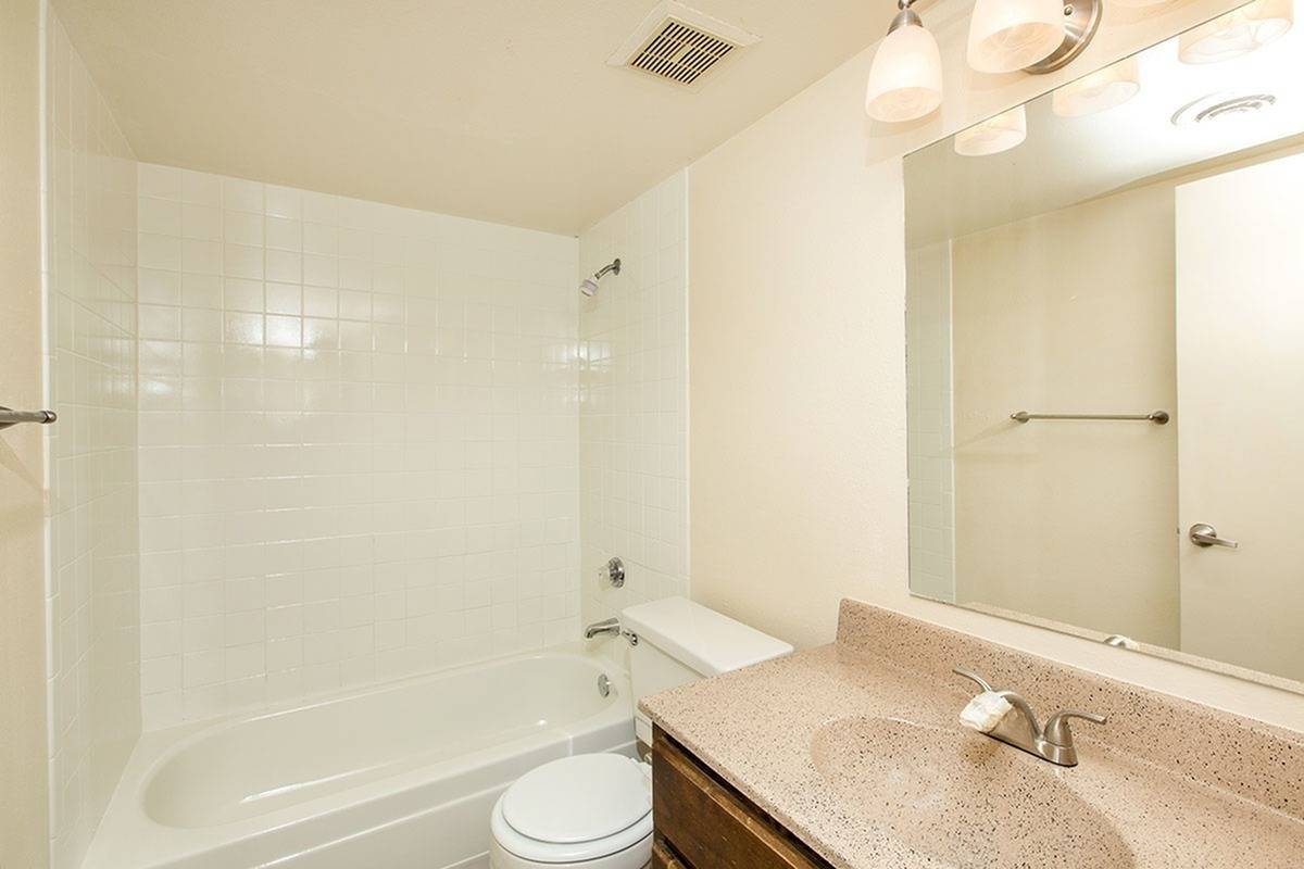 full bath with shower tub combo and beige vanity at Bridge Lane
