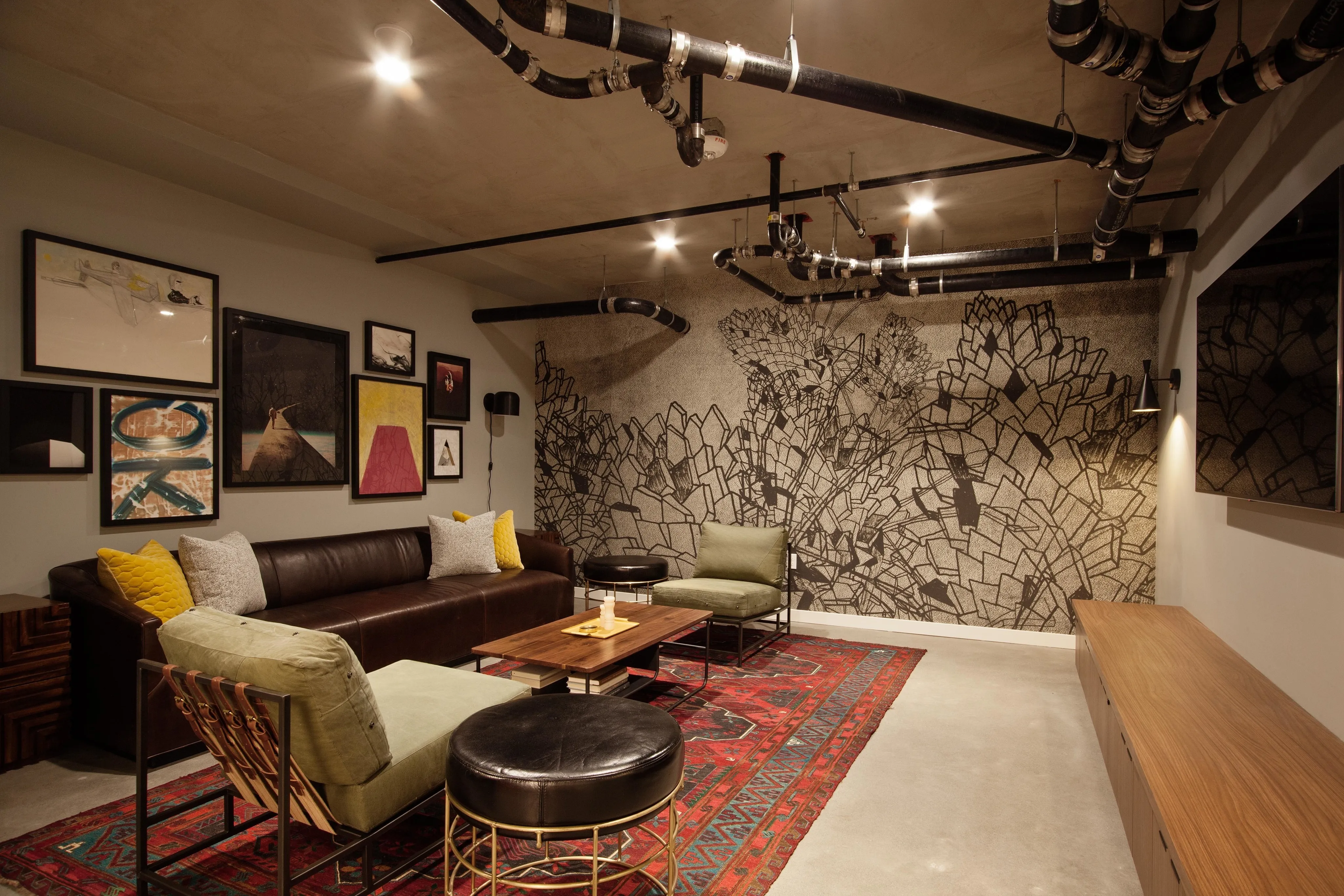 lounge area with leather sofa and arm chairs at oro apartments