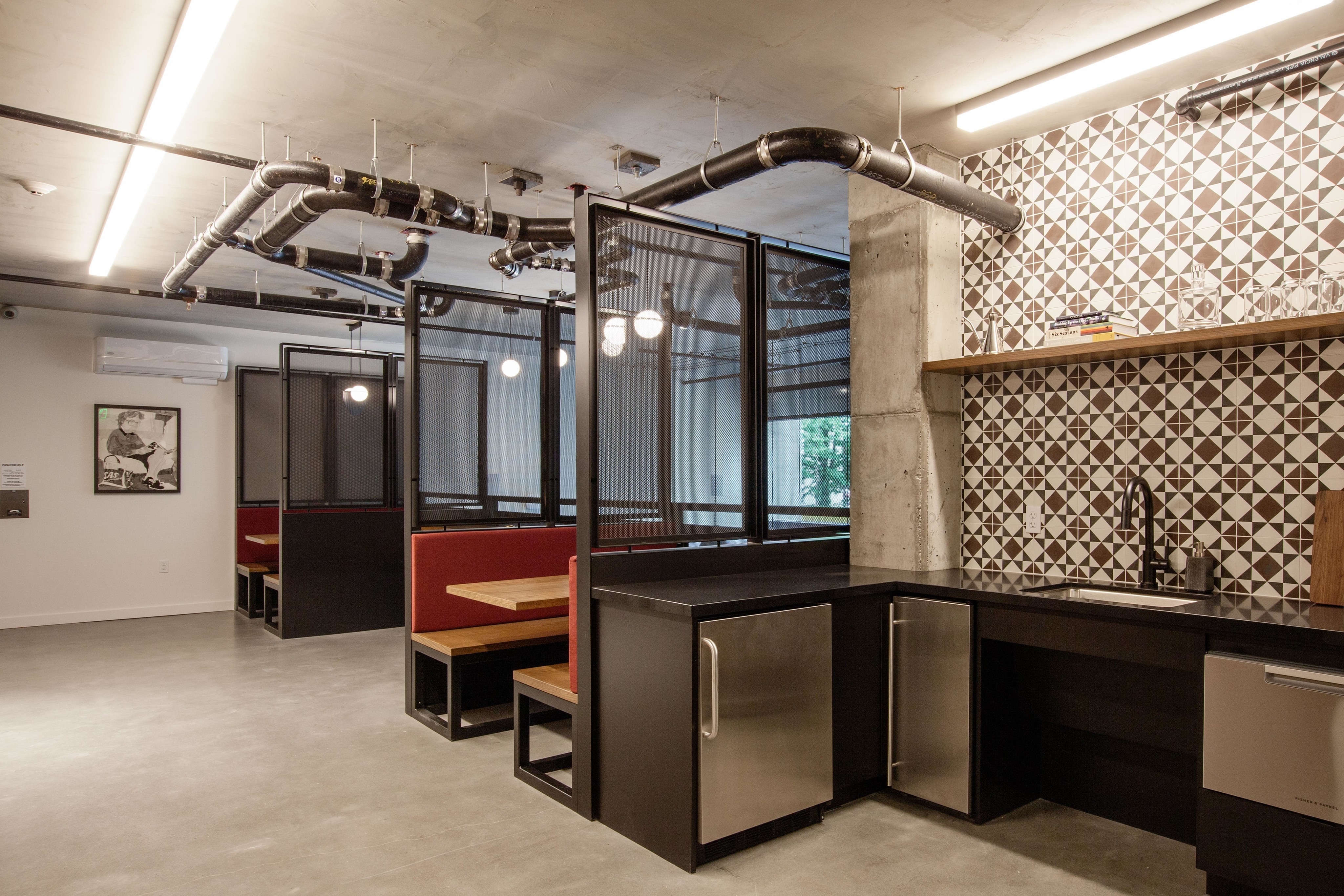 the mezz-semi private booths and sitting area with kitchen at oro apartments
