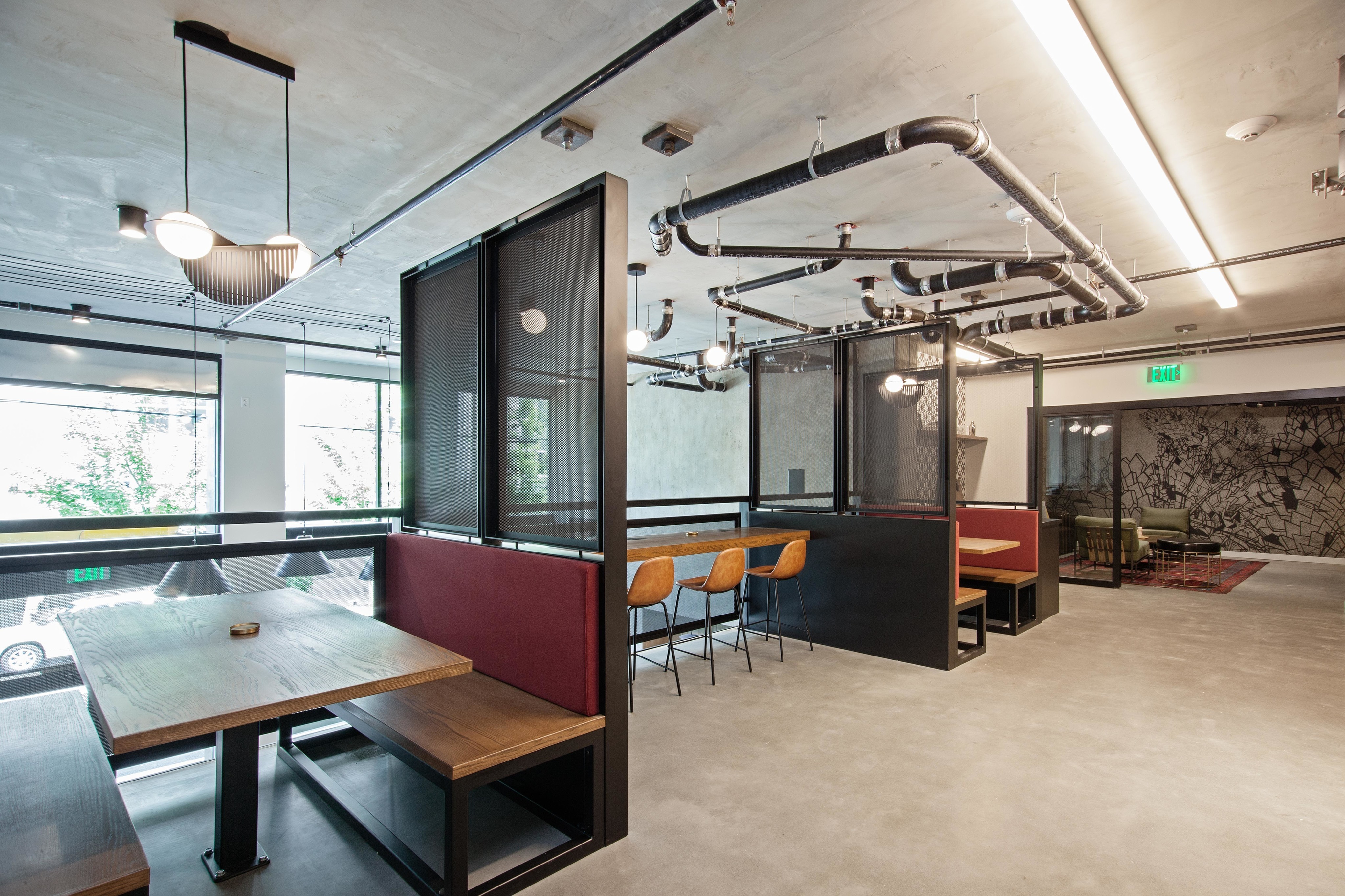 the mezz-semi private booths and sitting area with kitchen at oro apartments