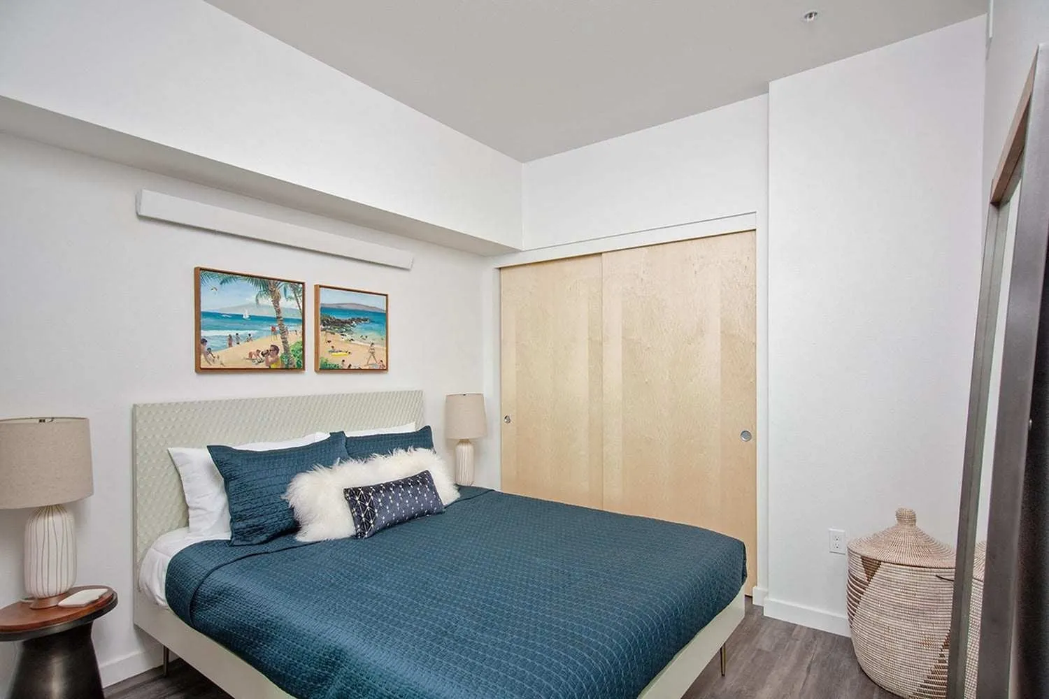 1 BR Apartments in Downtown Portland OR - ORO - An interior shot of The Bedroom with a Bed, a Large Closet, High Ceilings, Wood-Style Flooring, and Stylish Decor