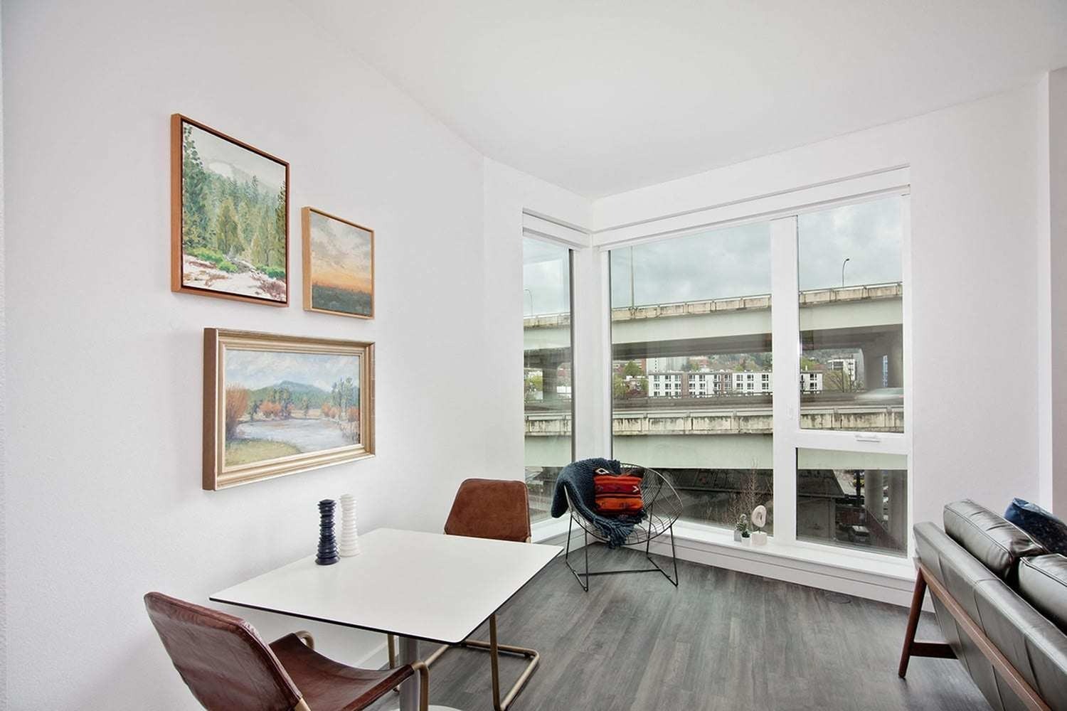 Downtown Portland Apartments - ORO - Dining Nook with Floor to Ceiling Windows and Wood-Style Flooring