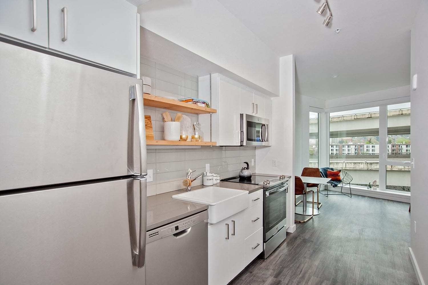 Pearl District Apartments - ORO- Kitchen with White Cabinets, Storage Shelves, and Stainless-Steel Appliances