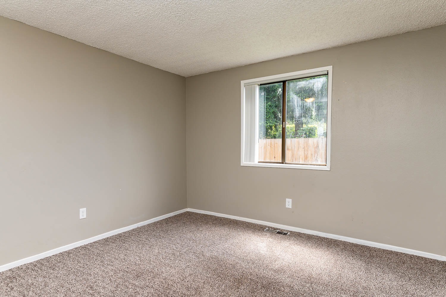 Large Bedroom with Window and Carpet