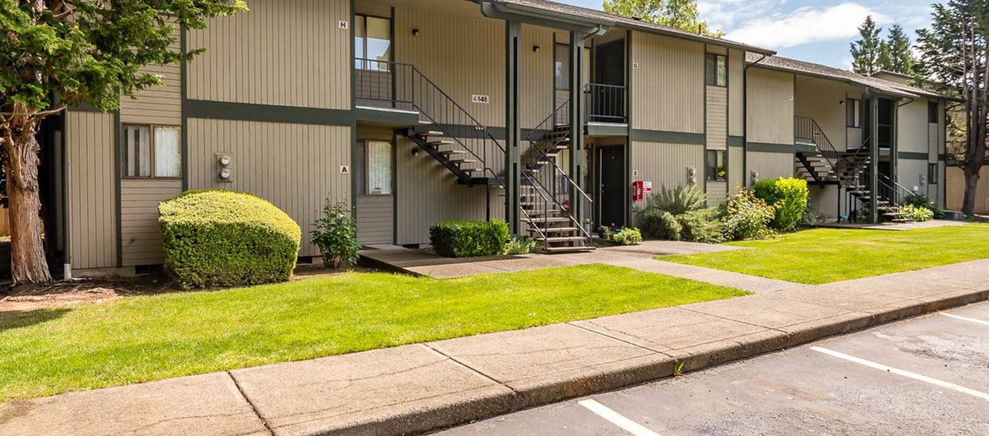Exterior picture of apartment building with grass  areas