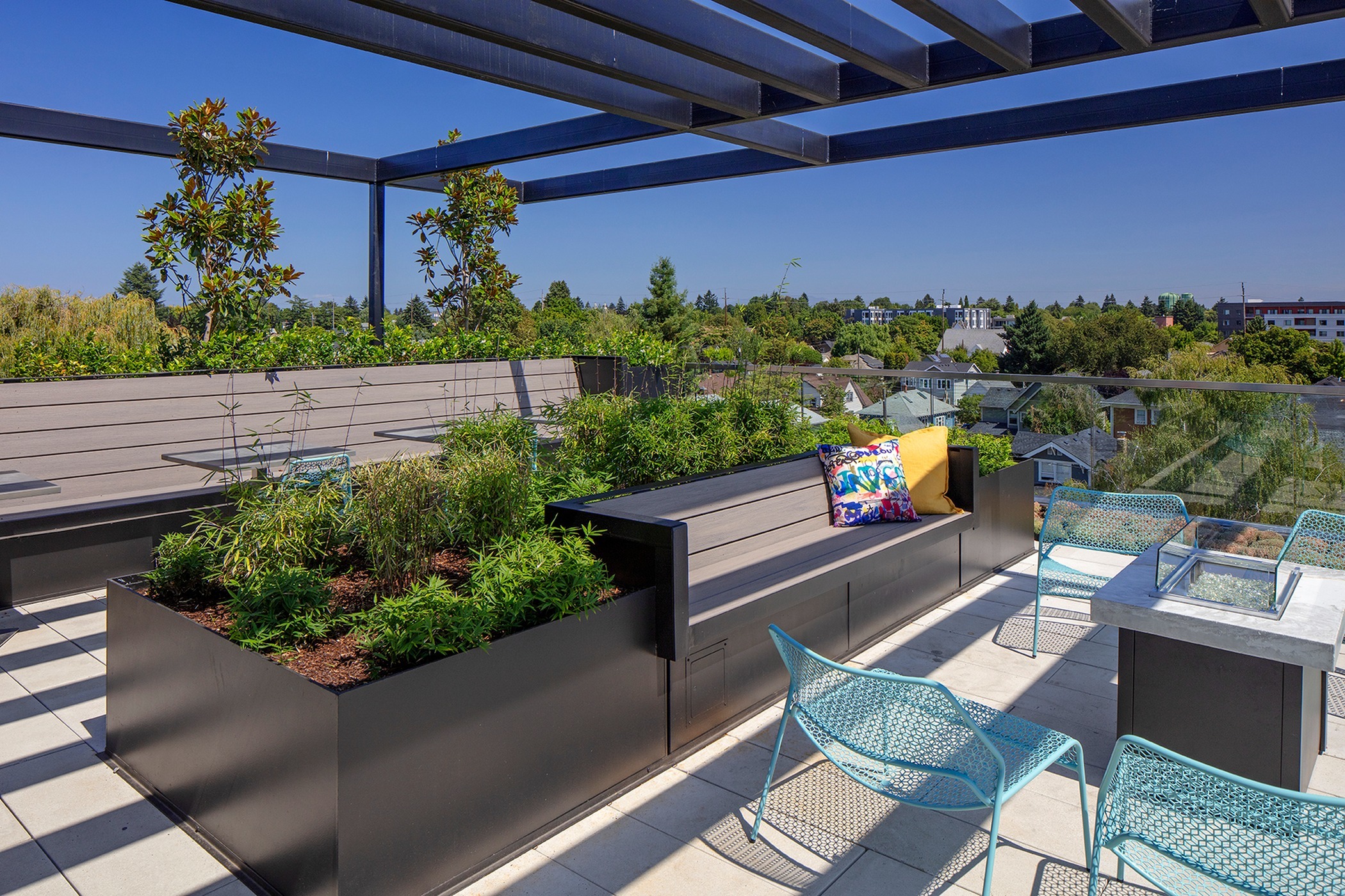 rooftop lounge with decorative plants and fire pit at parallax apartments