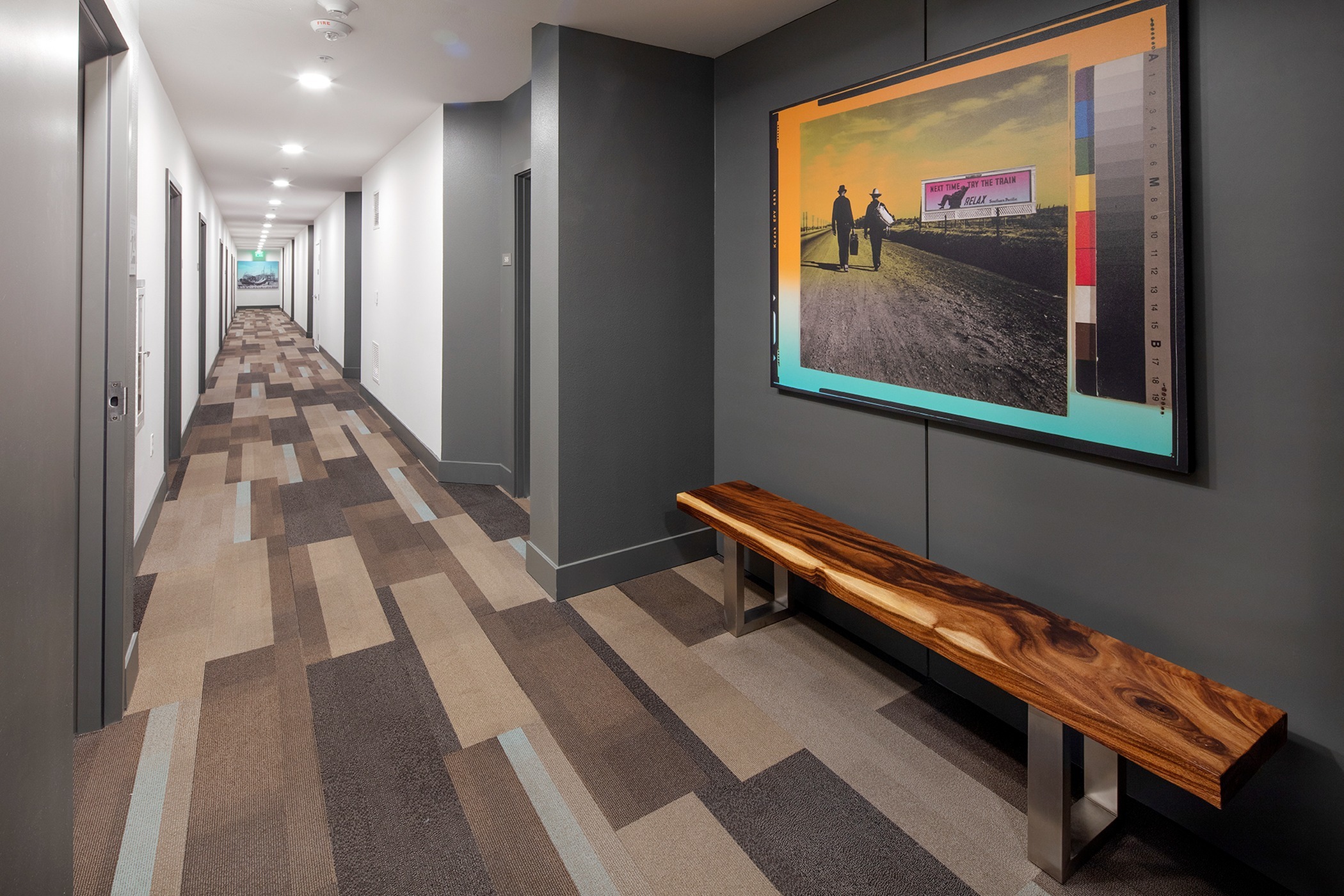 hallway with wooden bench and art work at parallax apartments