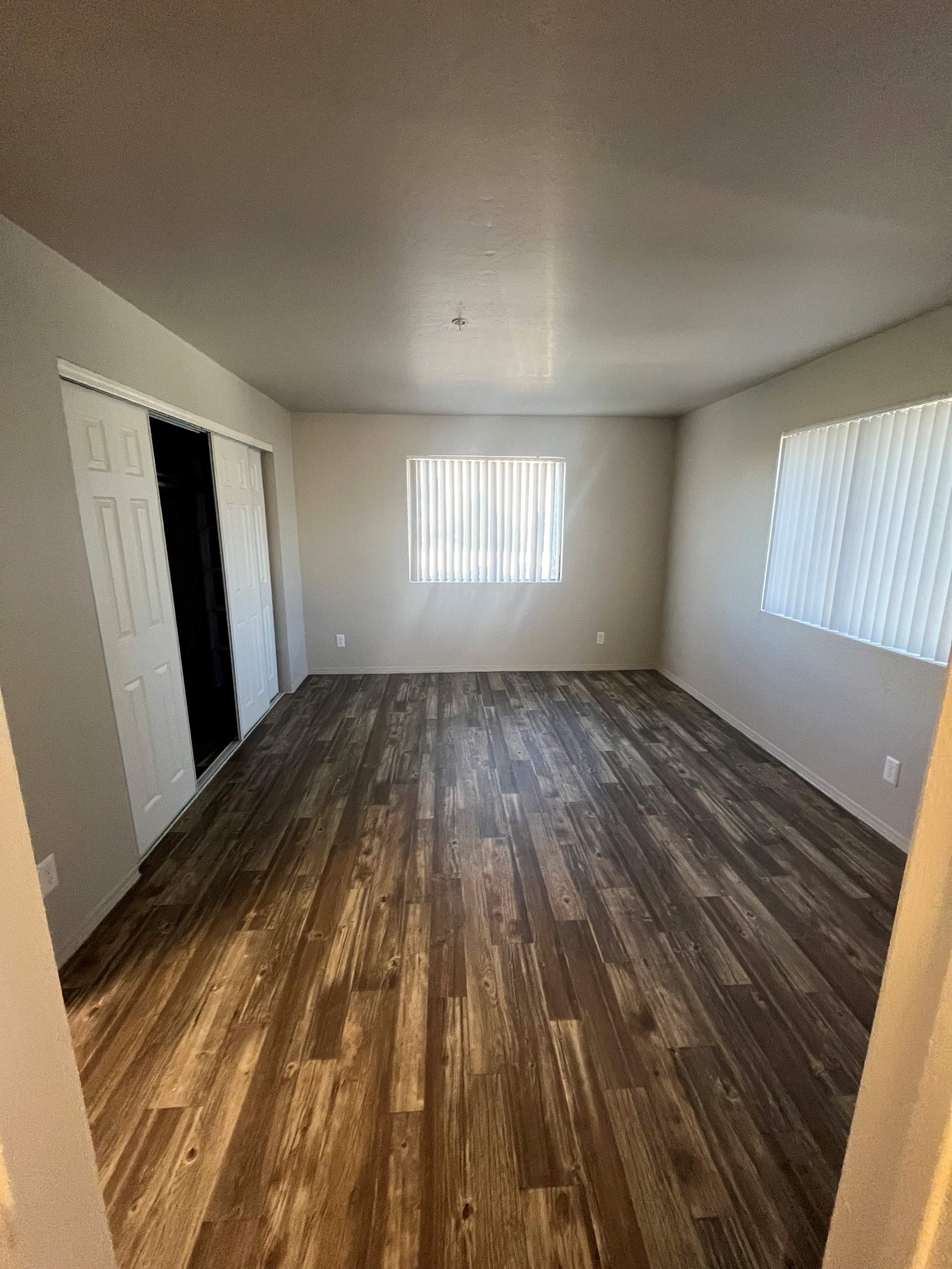 bedroom with two windows and full closet and storage