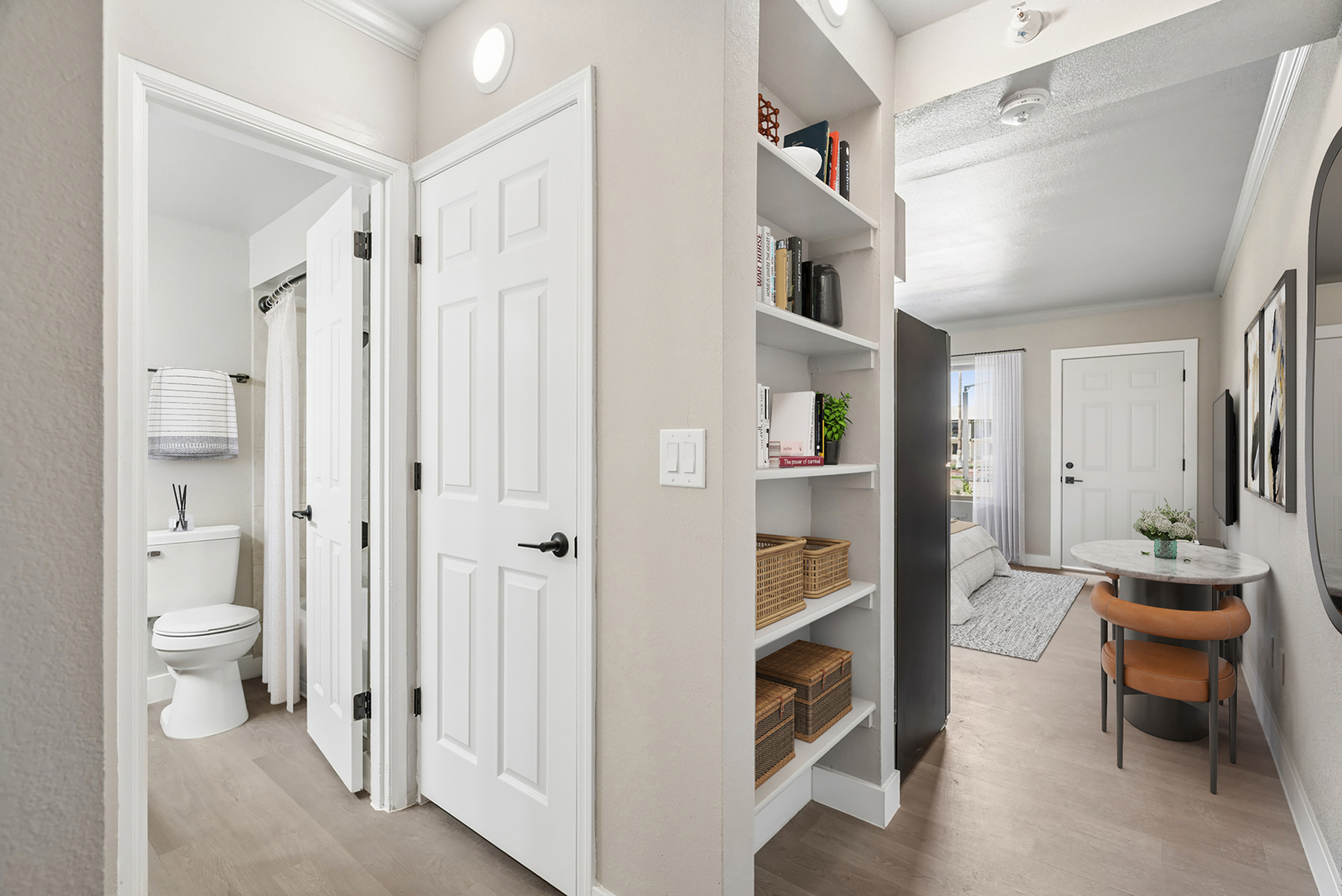 Virtually staged studio at Solaris at Tucson showing the hallway into the bathroom