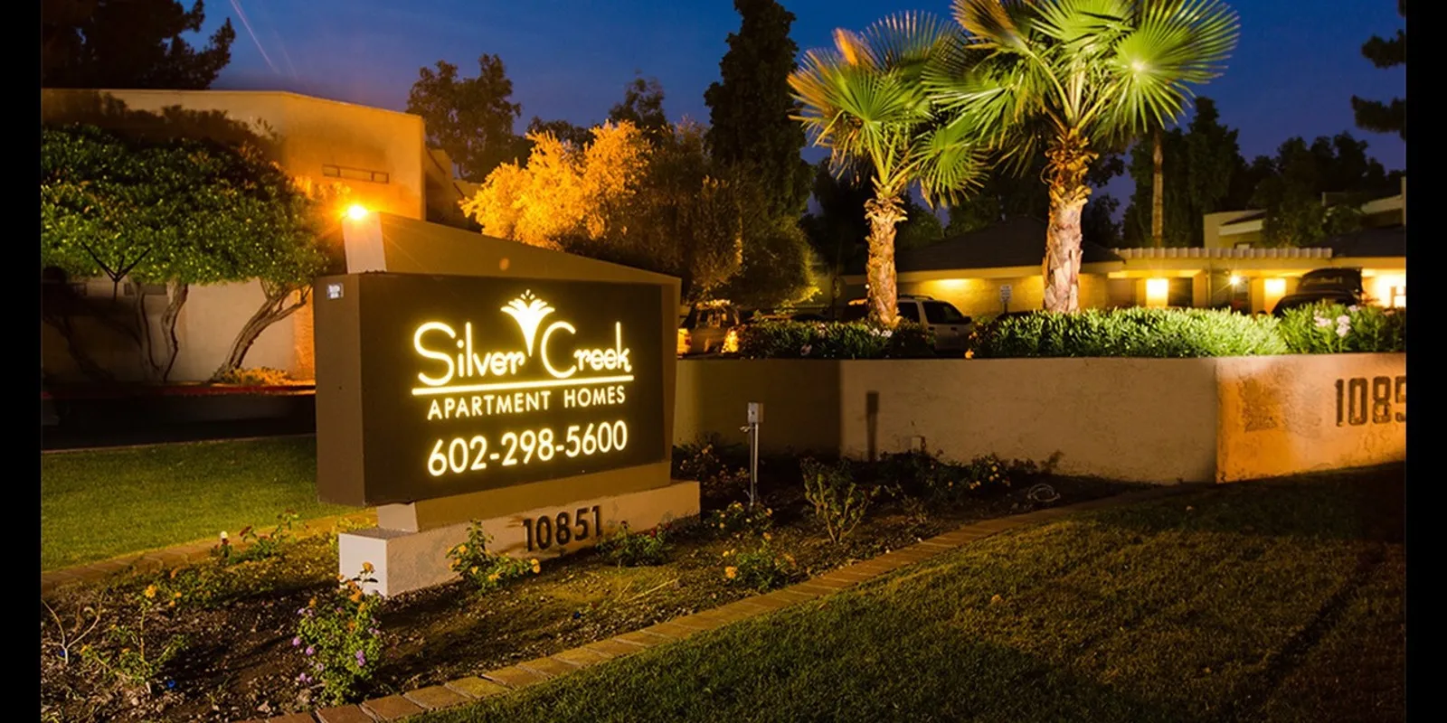lit silver creek apartments monument sign at night