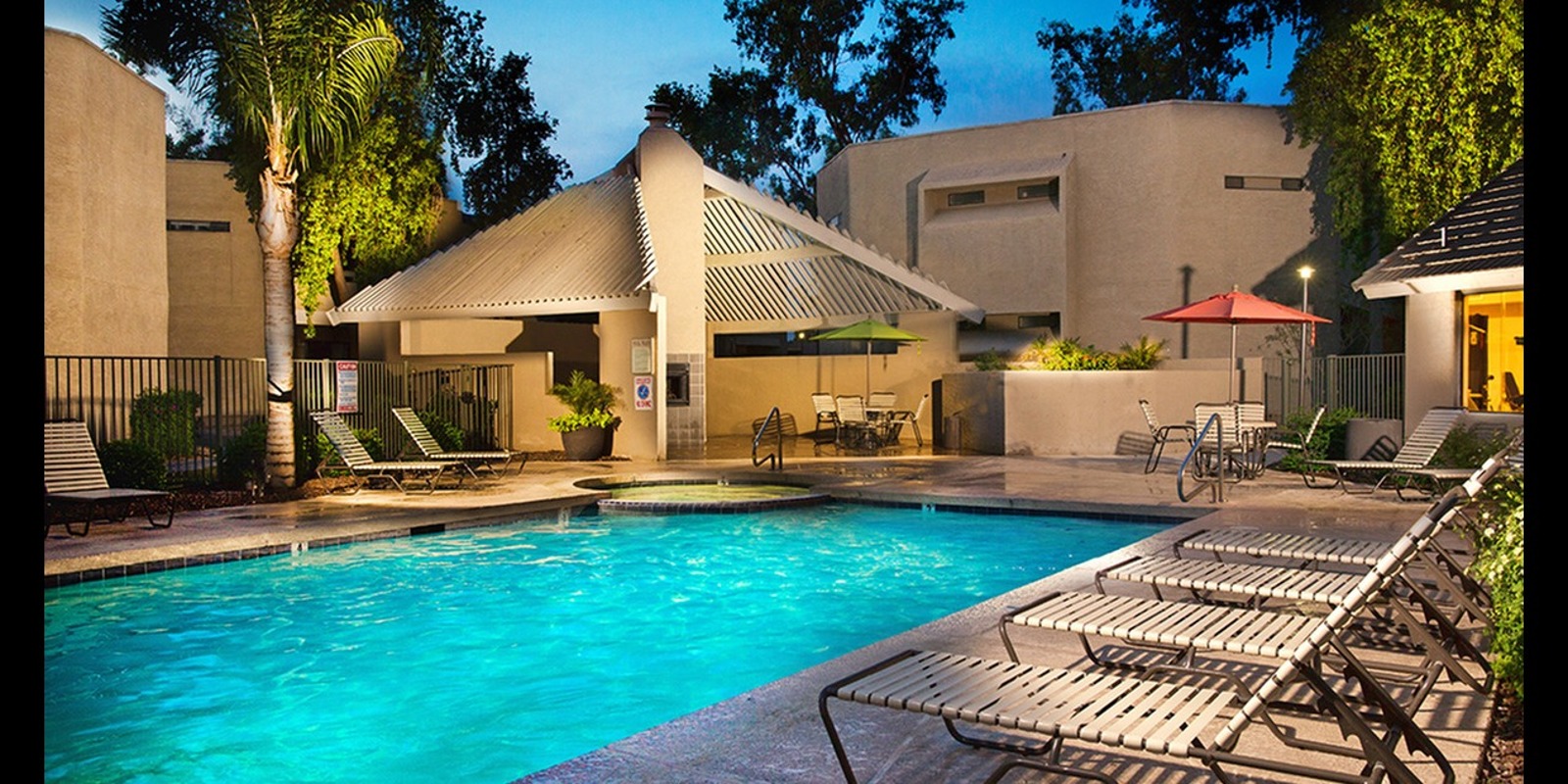 lit pool with lounge chairs at silver creek at night