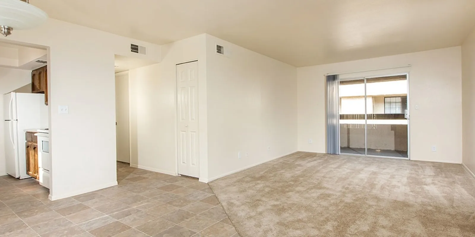 living room with brown carpet and glass sliding doors to patio