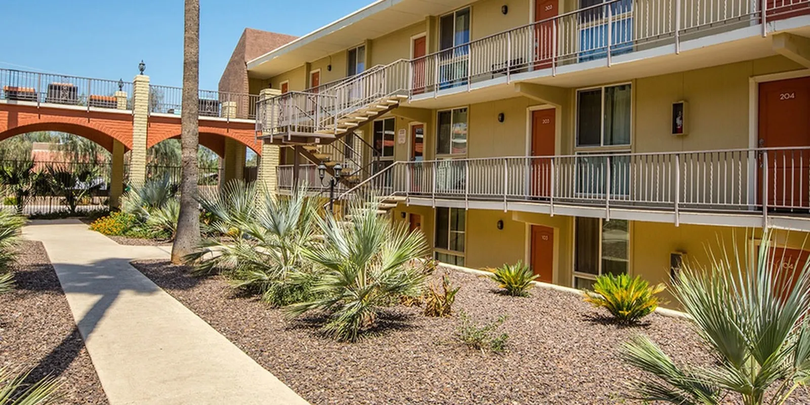 walkway and three story apartment building