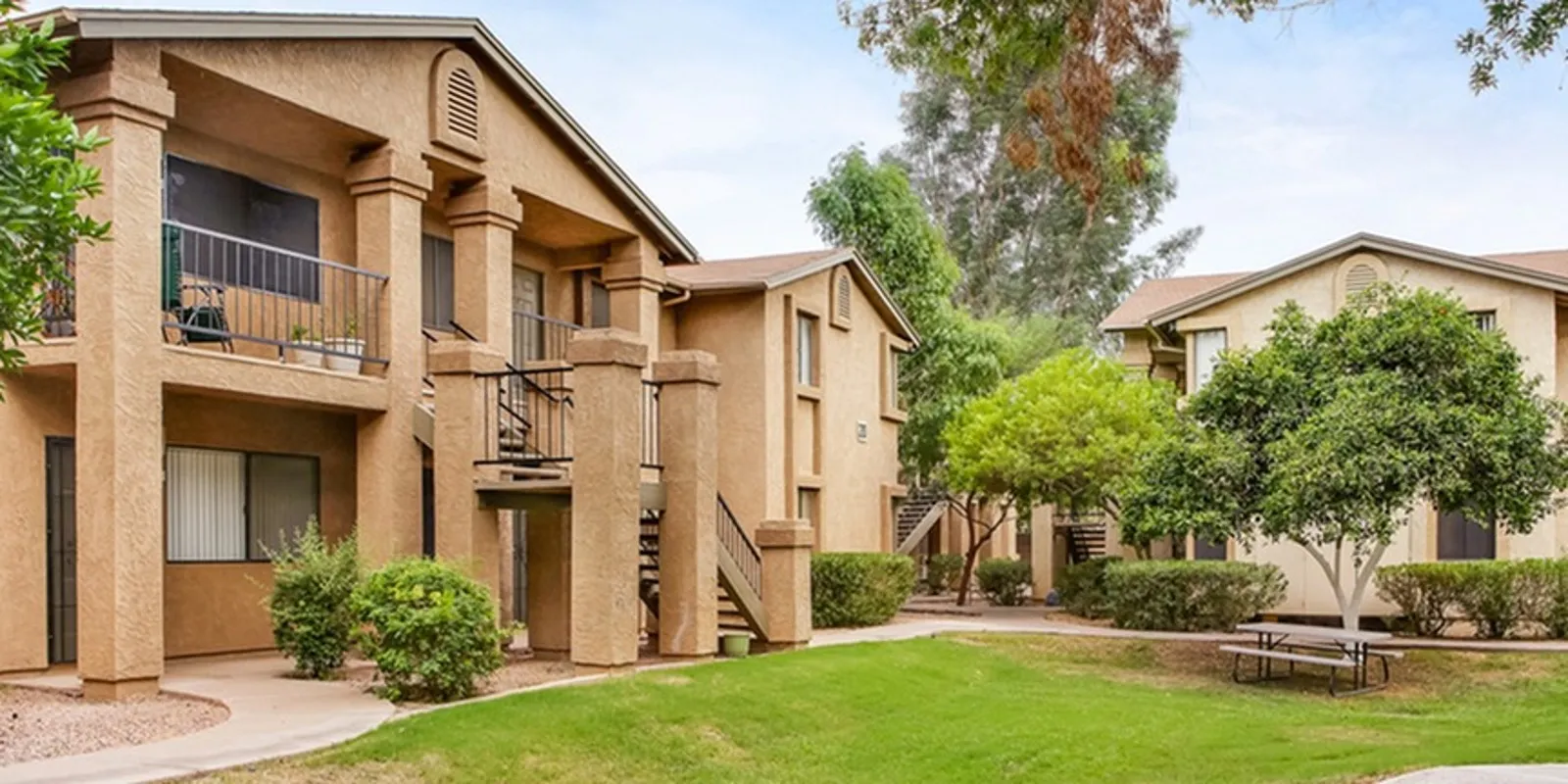 grassy courtyard and 2 story apartment building at orchard mesa