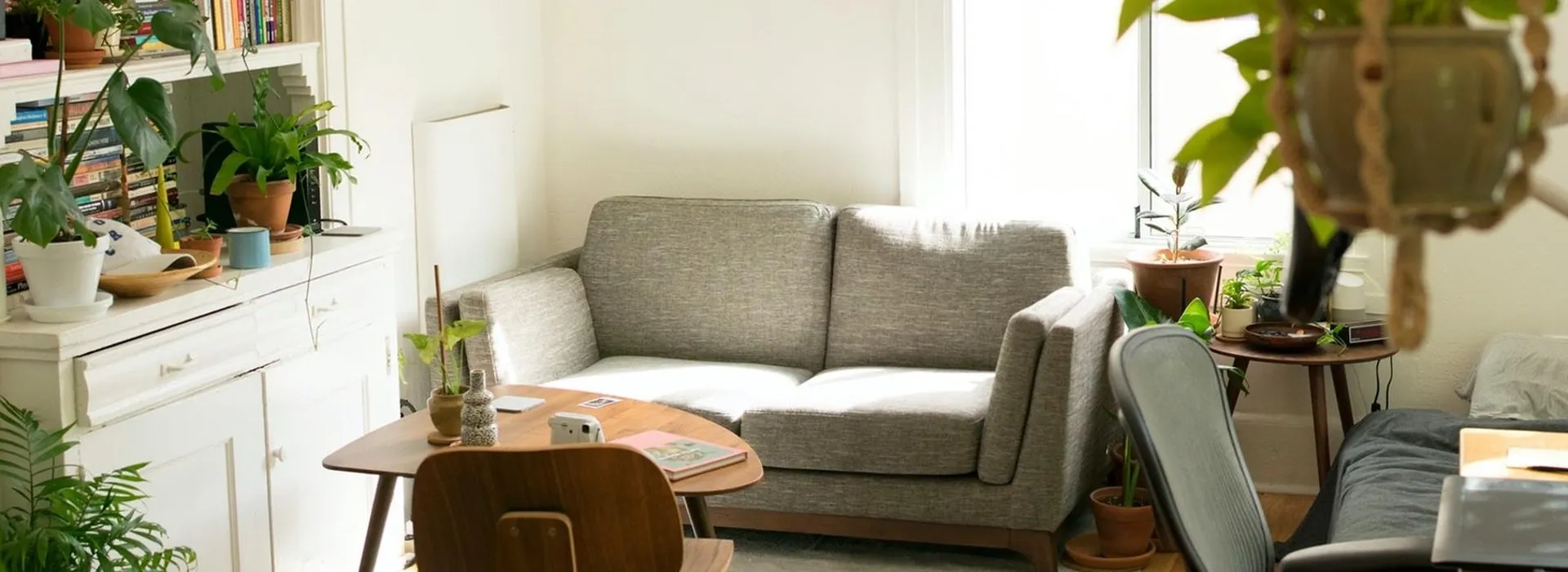 living room with grey sofa and eames chair