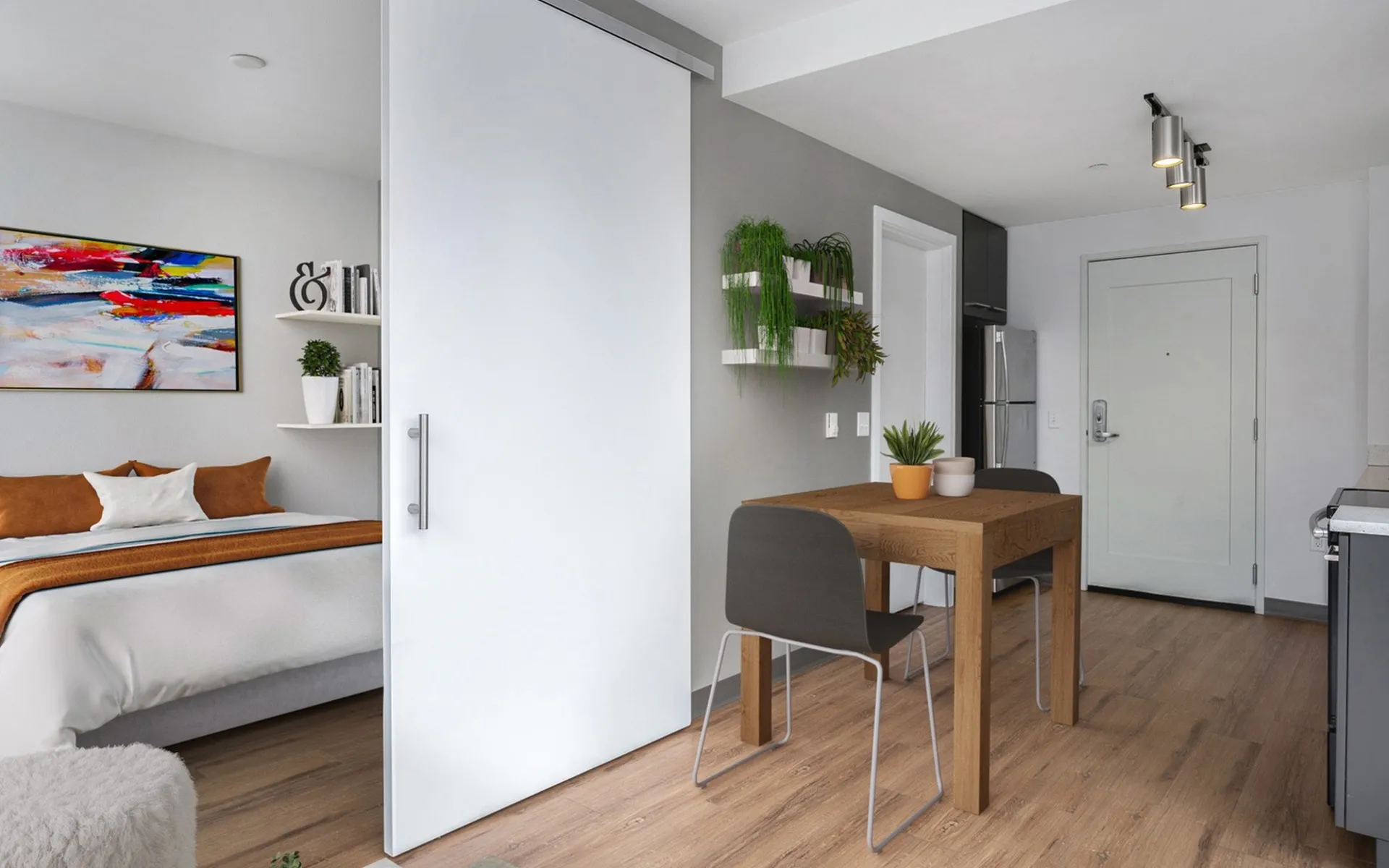 Kitchen and bedroom room areas, stainless steal appliances and wood laminate flooring
