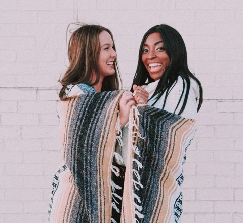 two women wrapped in the same blanket