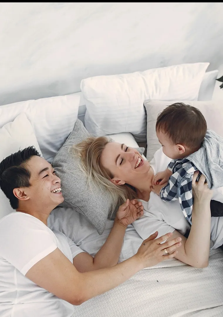 couple in bed with child