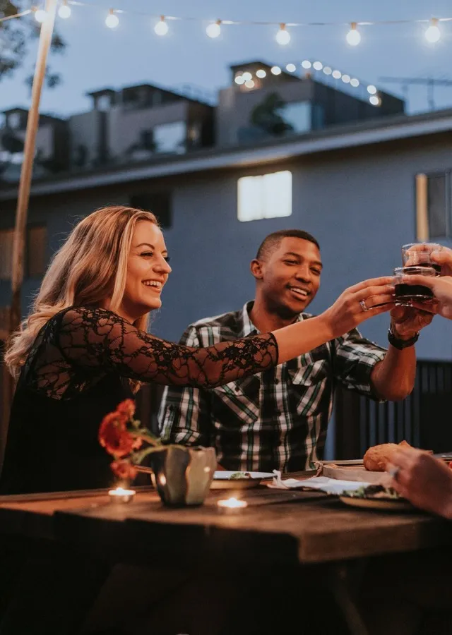 2 people having a toast outdoors