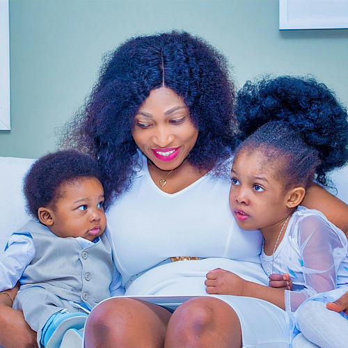 woman in between two small children on a sofa