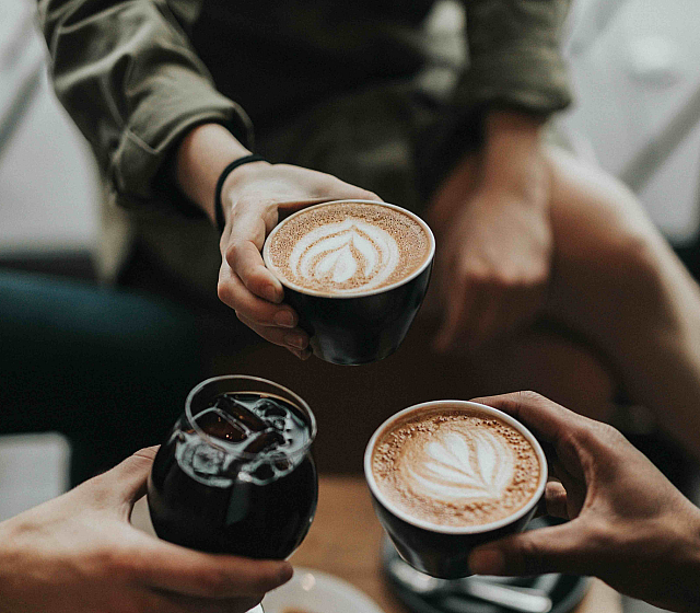 people toasting with coffee