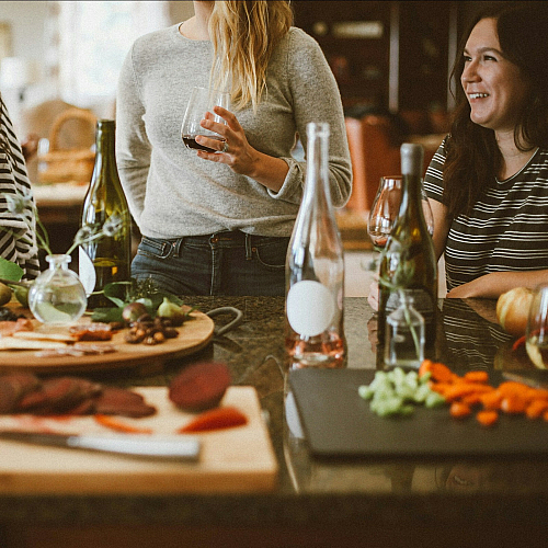 friends sharing wine and a charcuterie board