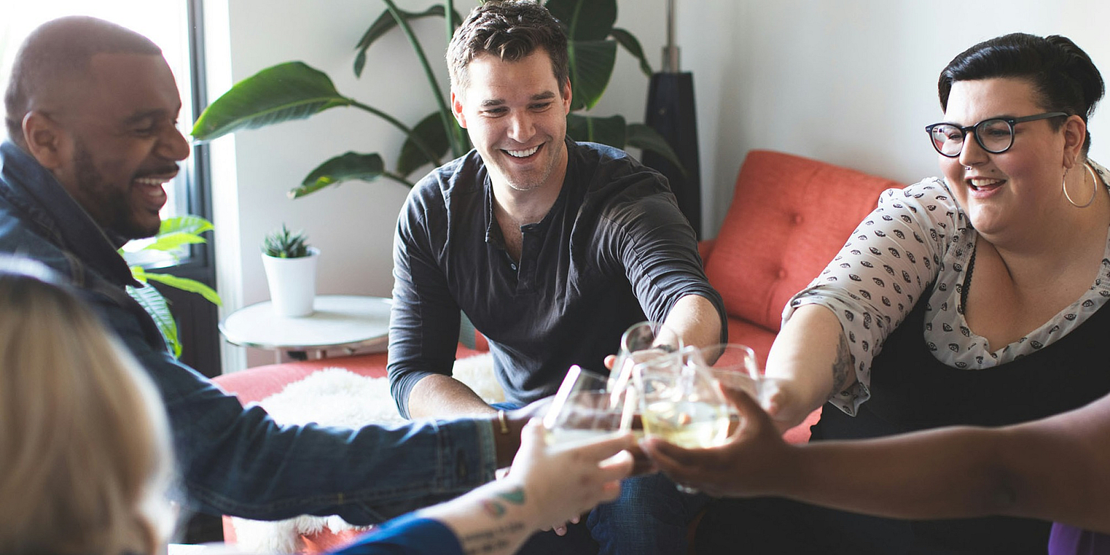 friends toasting together in a living room