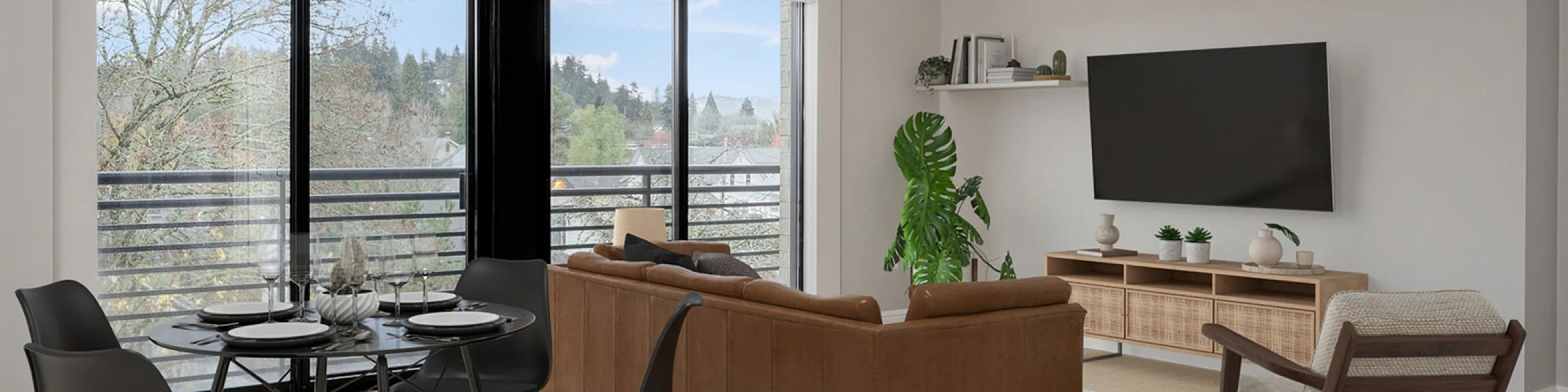 open layout kitchen and living room with taupe loveseat and leather armchair