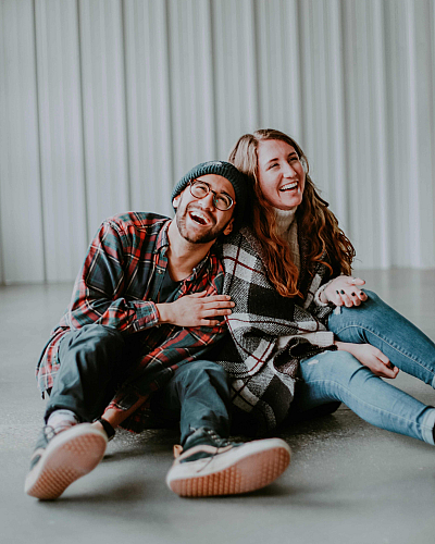 two-people-sitting-on-the-floor-having-a-good-time