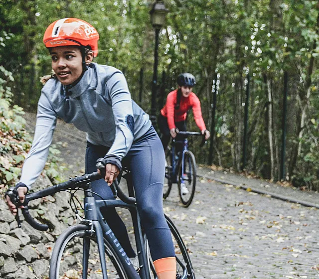 two women riding bicycles on a trail