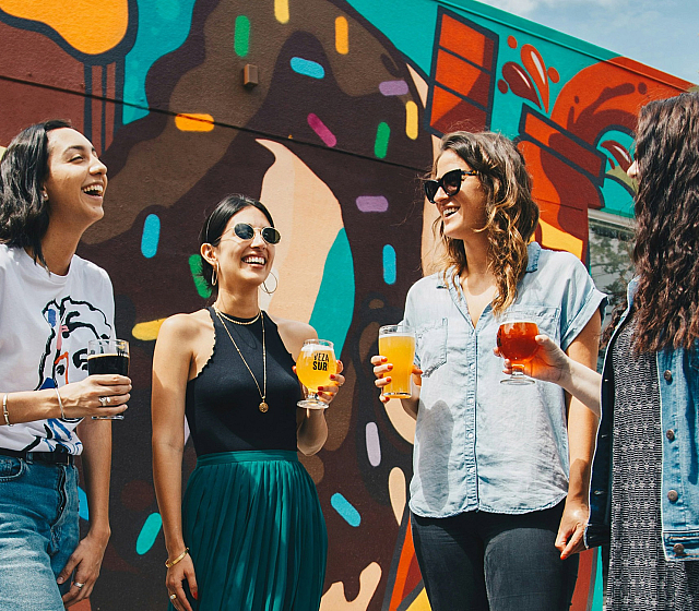 four women enjoying drinks outside