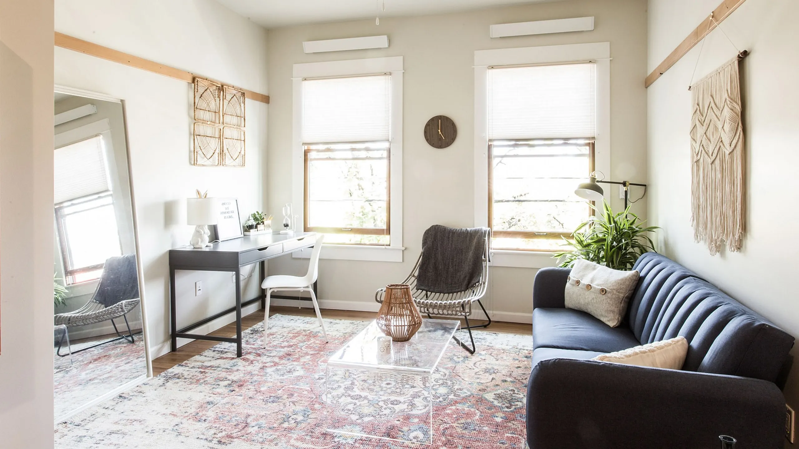 living room with blue sofa large persian rug with glass coffee table at fairmount apartments