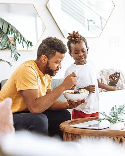 adult sharing bowl of food with child