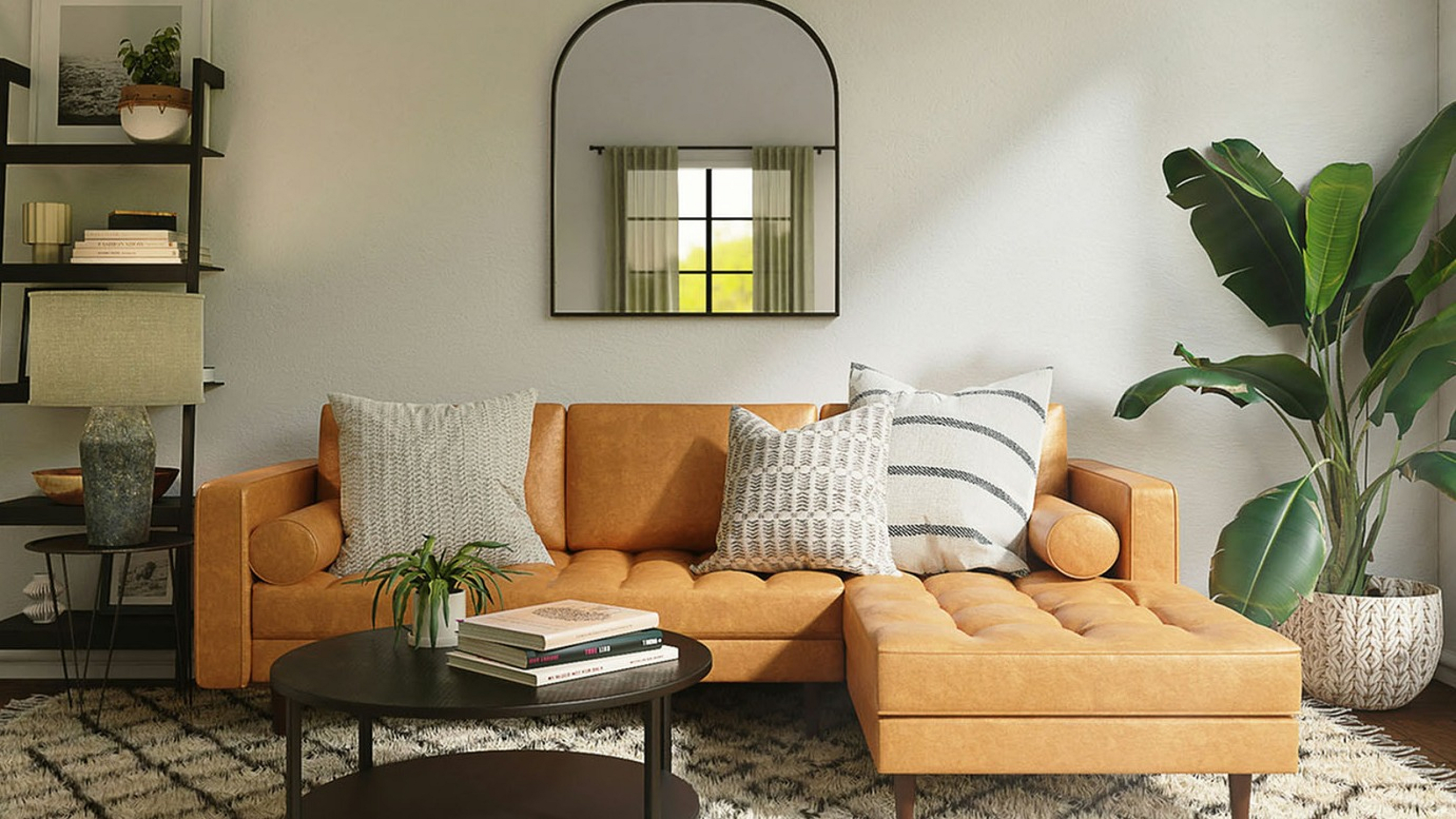 brown leather sofa with decorative pillows and round brown coffee table