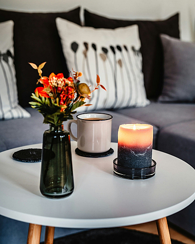 coffee table with decorative items and sofa in the back