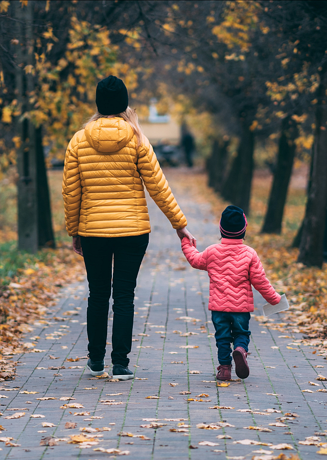 woman walking with child in hand