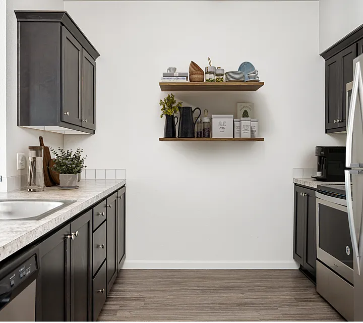 kitchen with stainless steel appliances and wood like vinyl flooring at alderbrook