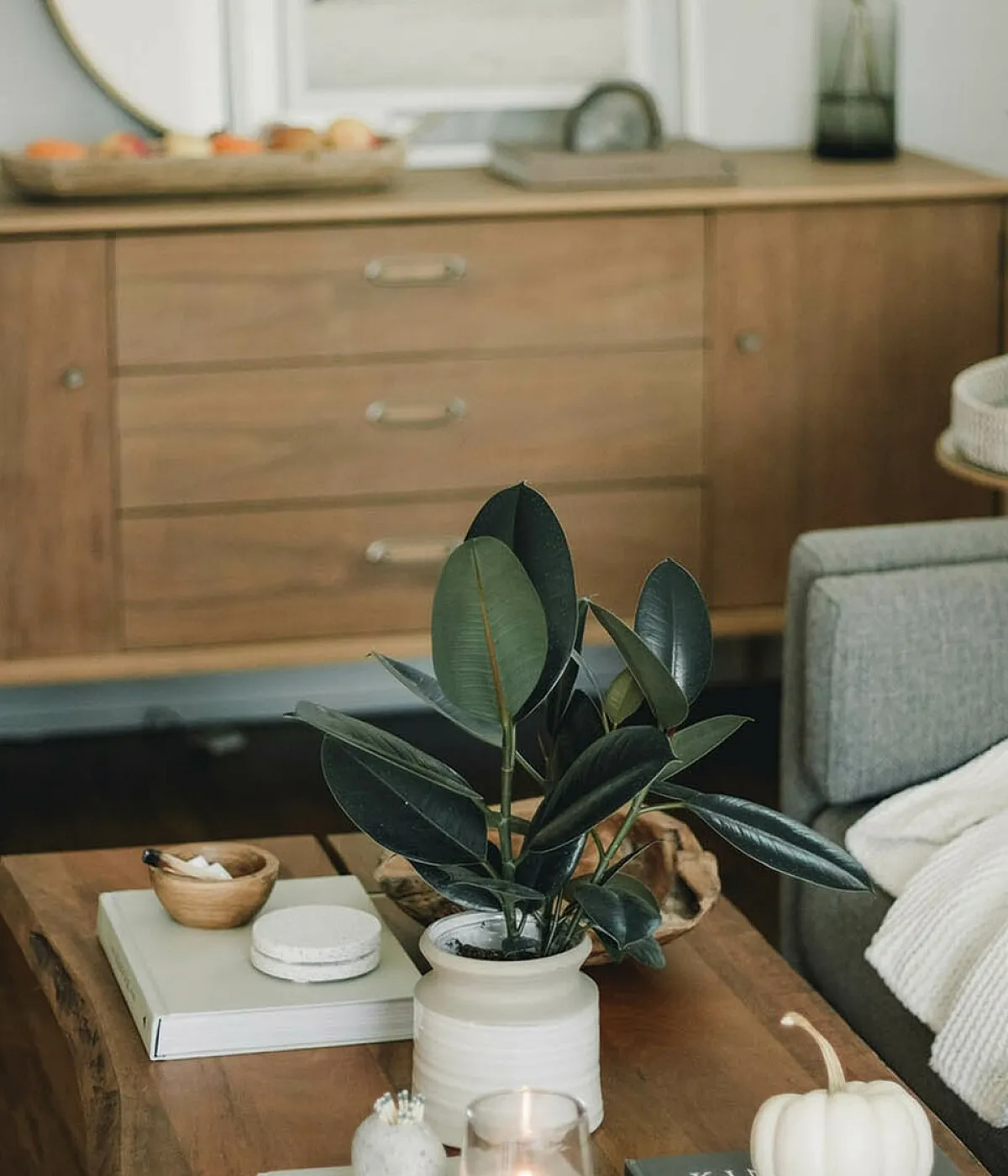 coffee table with decorative items and console in the background