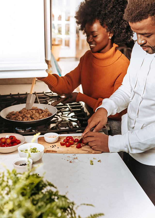 two people cooking together