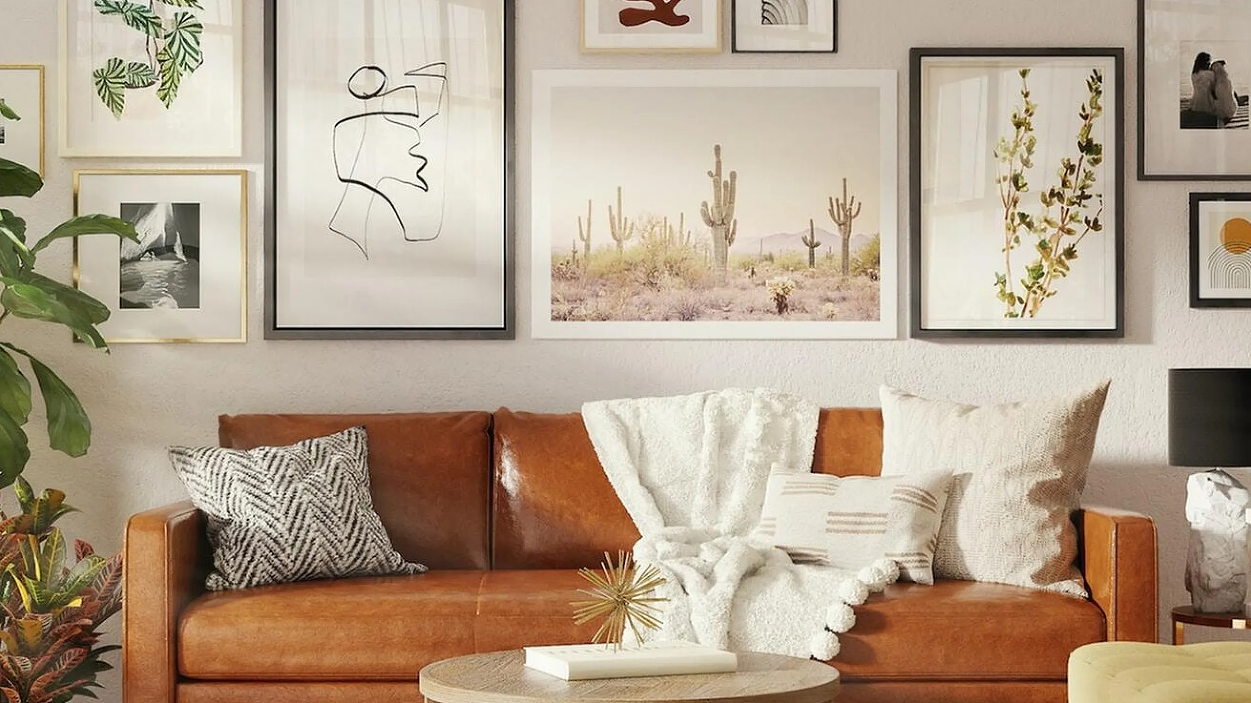 brown leather sofa with many art frames hanging behind