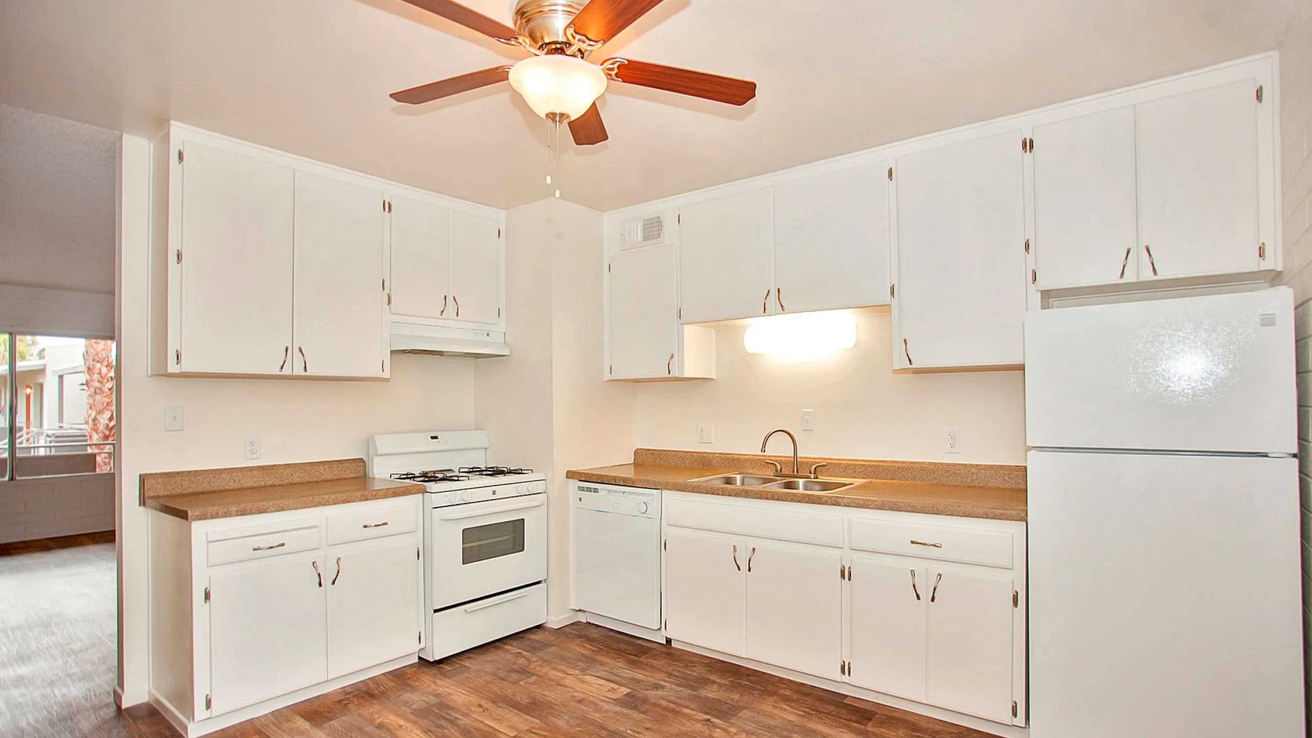 kitchen with white appliances and faux wood flooring at solaris on university