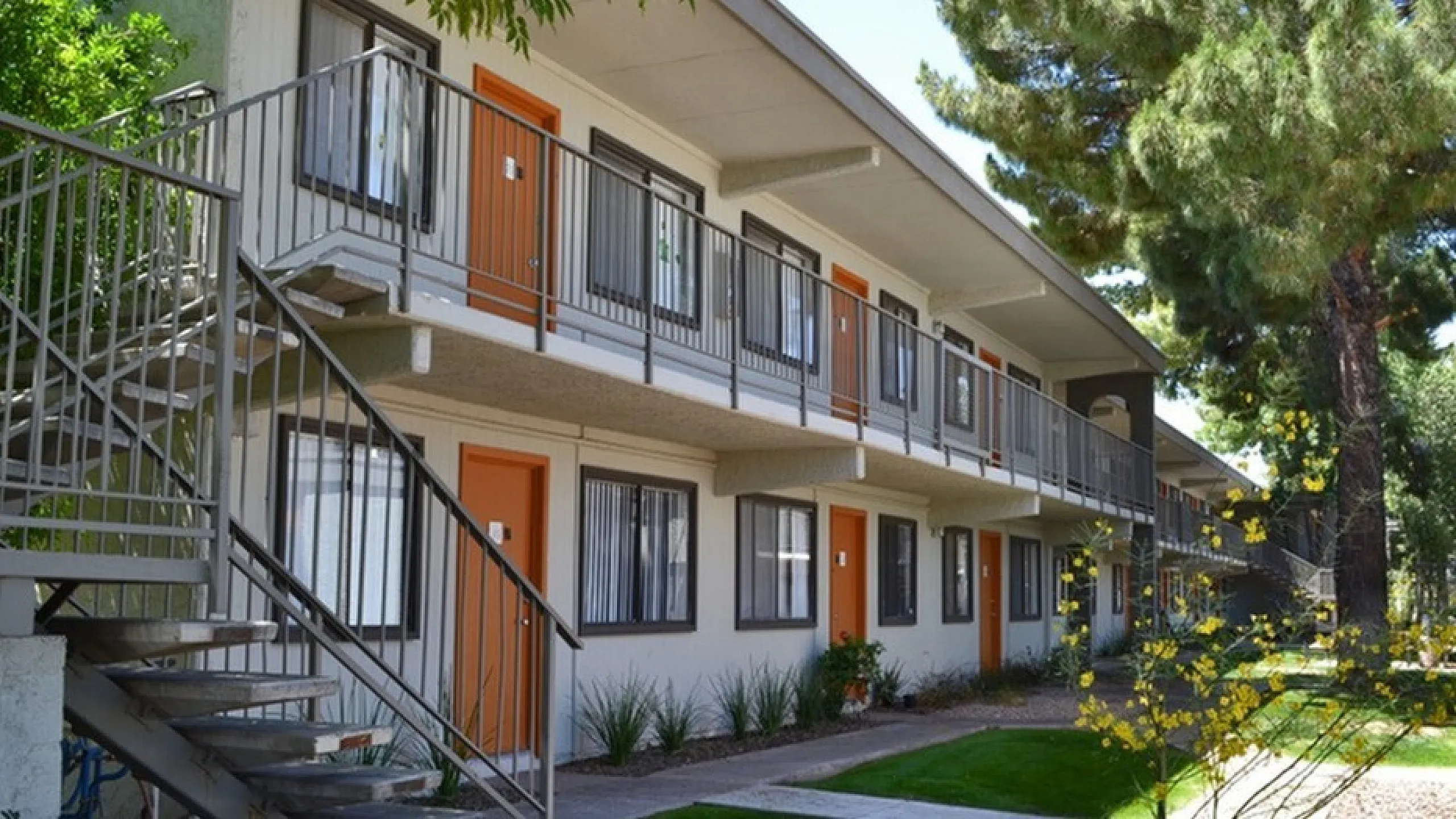two story apartment building with orange front doors at solaris on university