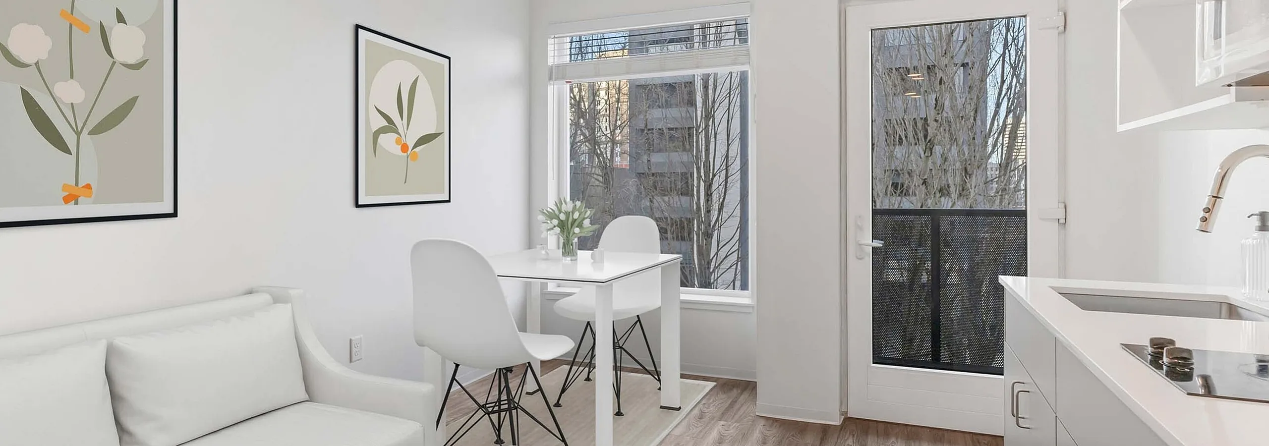 Staged studio living room with dining area and balcony at Koz on 4th.